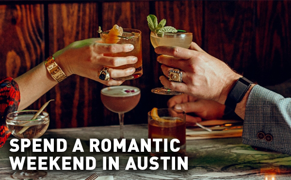 Two hands toasting drinks on a romantic date in Austin, Texas