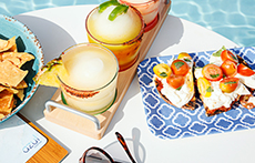 Platters of drinks and bites at the Azul Rooftop pool at The Westin Austin Downtown