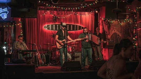 A four-member band performs on The Continental Club stage