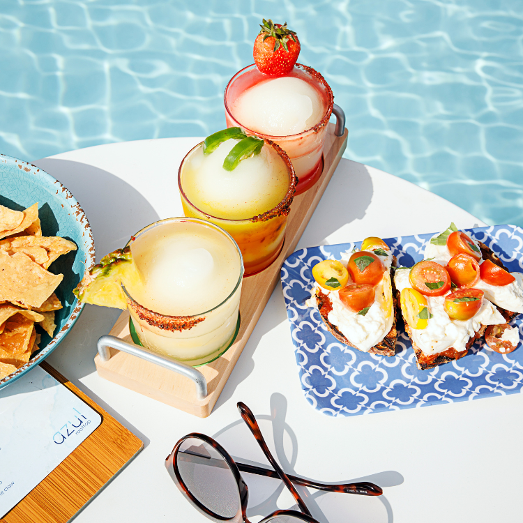 Platters holding tropical drinks and small bites poolside at Westin Austin Downtown 