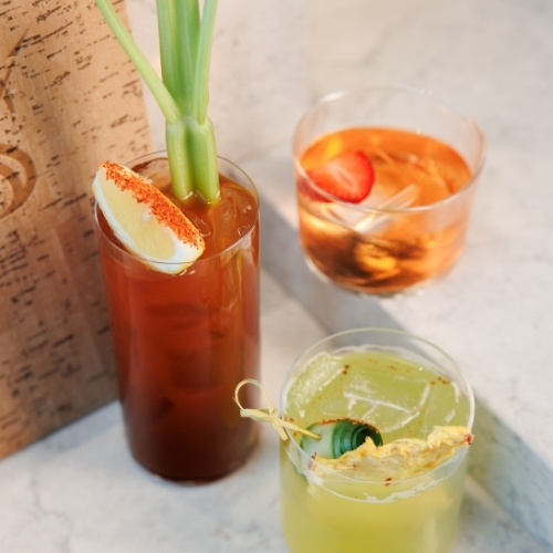 A Bloody Mary and two other cocktails with garnishes that are served at Skipjack Oyster in Austin, Texas Sub Headline 1: Seafood Brunch, Austin Style