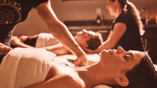A man and a woman receive a couples massage at Viva Day Spa in Austin