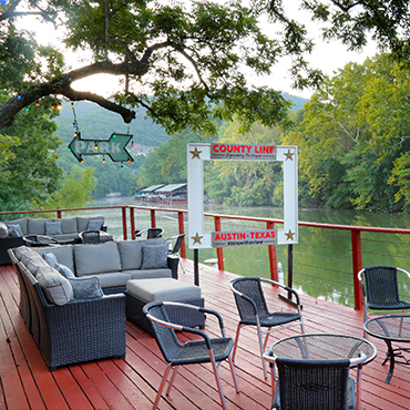 Creekside views from an outdoor deck at The County Line Bar-B-Q, Austin, Texas