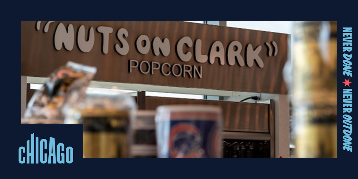 Snack items and the Nuts on Clark shop sign inside Midway International Airport
