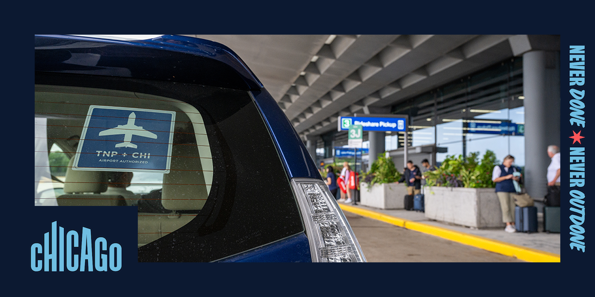 A rideshare vehicle with a Transportation Network Provider (TNP) decal waits curbside at Chicago O'Hare International Airport