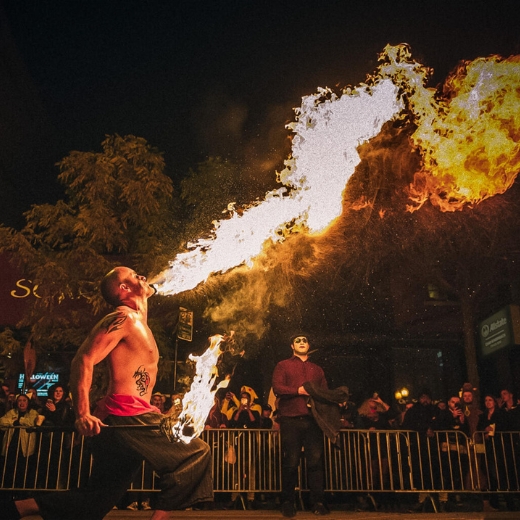 A fire-breathing performer wows the crowd during Chicago's Haunted Halsted Halloween Parade