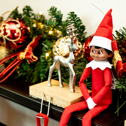 Elf on a shelf with other festive Christmas decor on a mantel in the Elf Life Suite at the Sheraton Grand Chicago Riverwalk