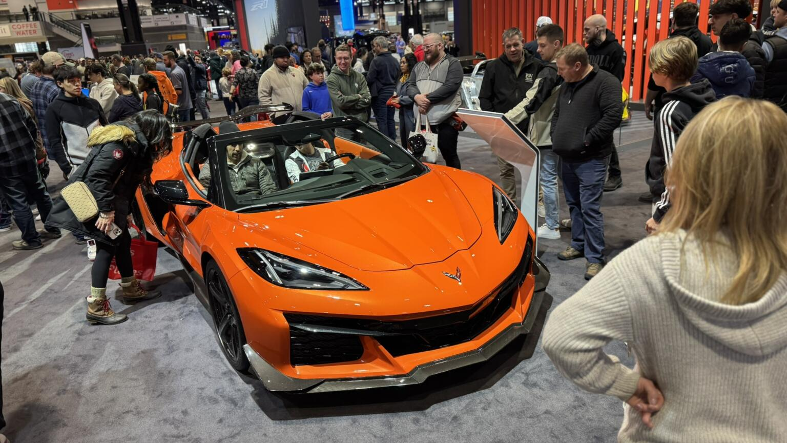 People gather around a new vehicle at the Chicago Auto Show