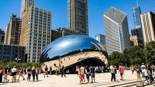 People gathered around the Cloudgate sculpture in Millennium Park