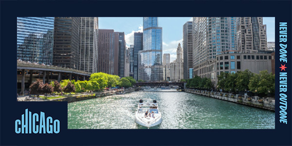 A boat cruises on the Chicago River with the Trump International Hotel & Tower Chicago in the background