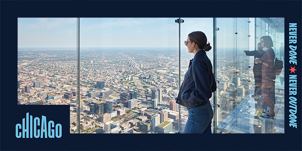 Three people look down at the city of Chicago from glass boxes at the Skydeck Chicago observation deck on Willis Tower's 103rd floor