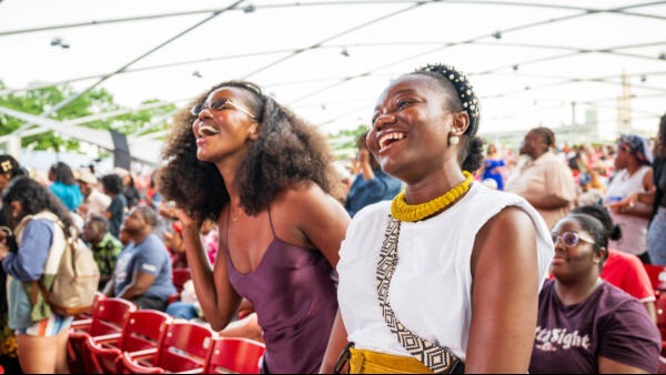 Two women smiling at an event in Millennium Park