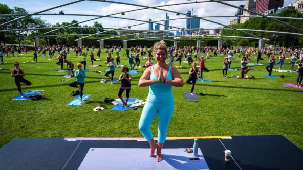An instructor leads an outdoor exercise class at Millennium Park