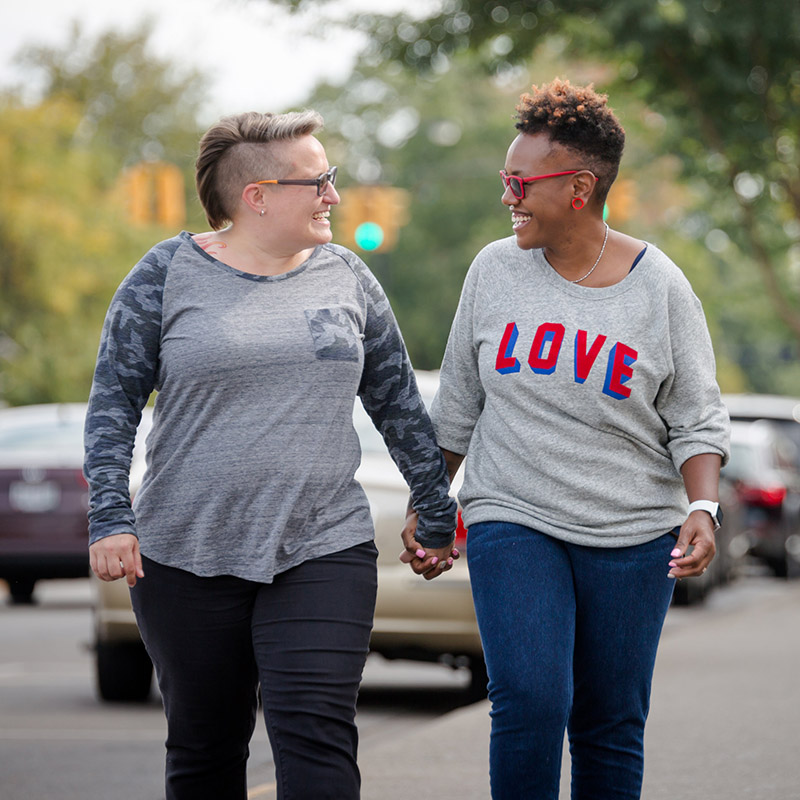 Image of two people holding hands