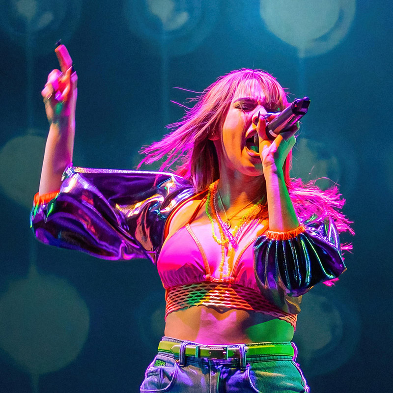 Image of a woman singing on stage.