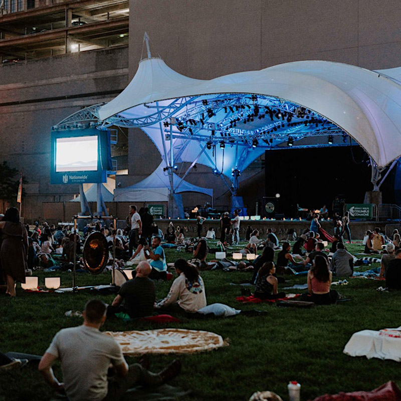 Image of people laying on the lawn at Columbus Commons.