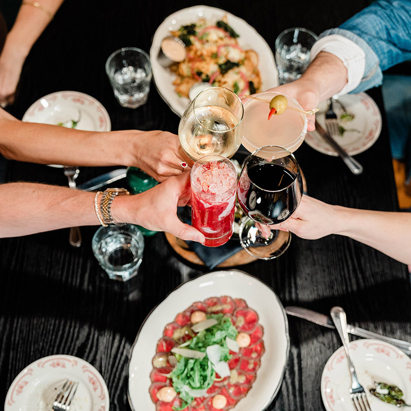Image of people eating and drinking at a restaurant.
