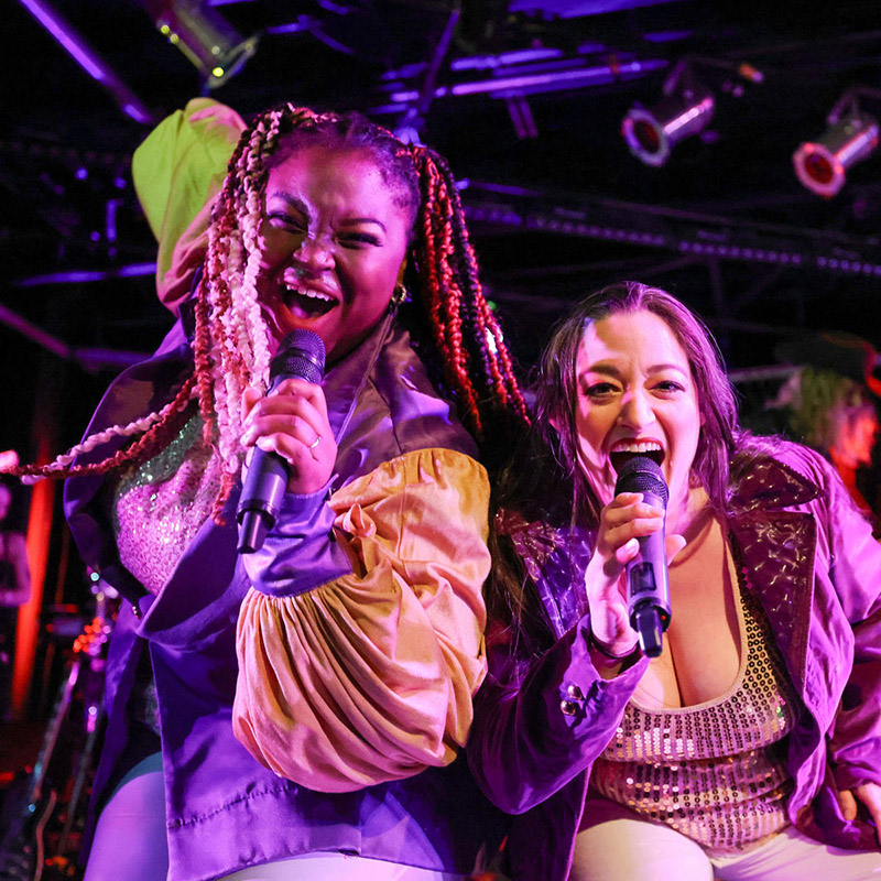 Image of two people singing.