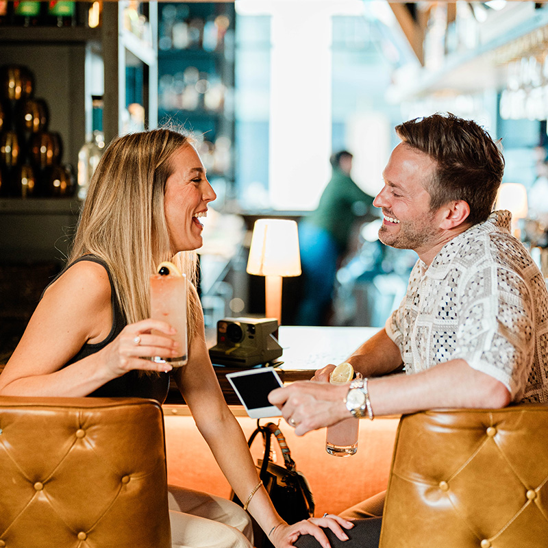 Two people enjoying drinks at Little West Tavern in Franklinton.