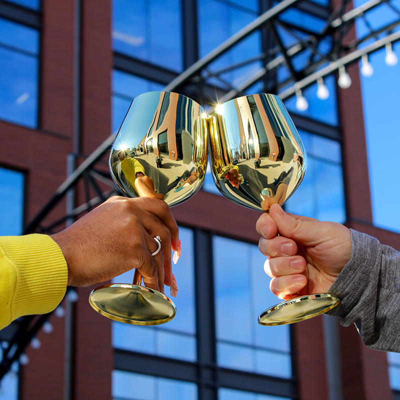 Image of two gold wine glasses. 
