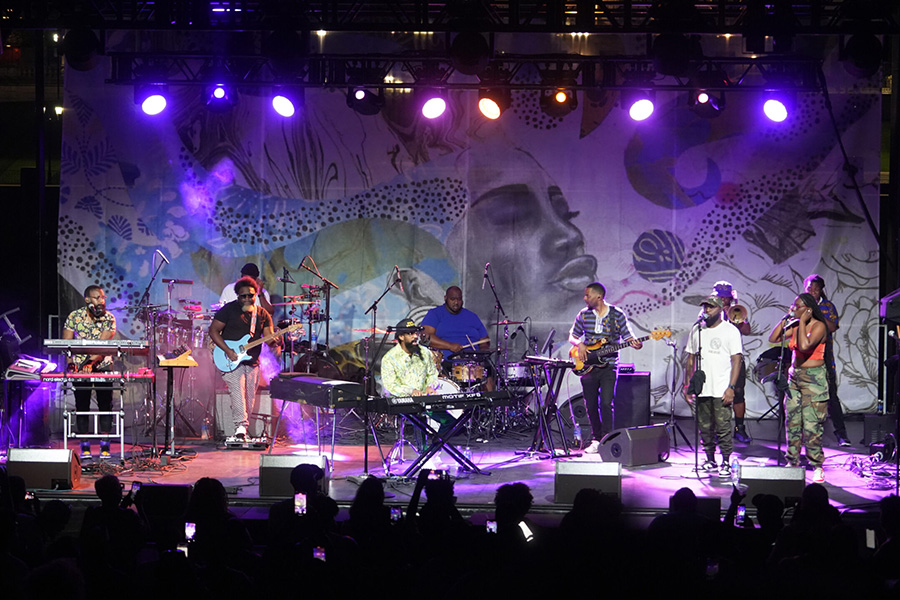 Image of a band playing on a stage.