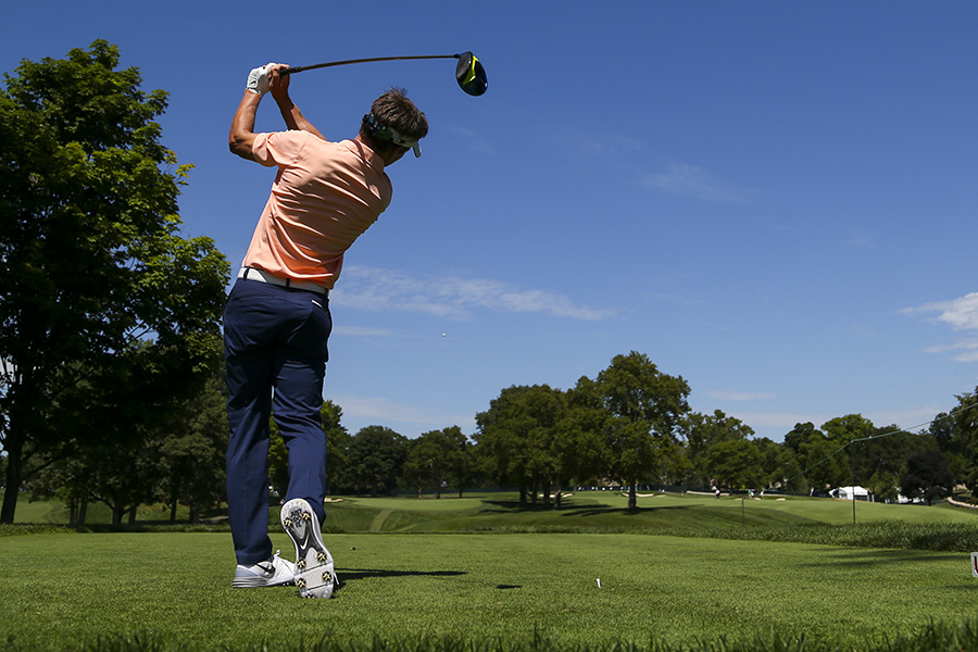 Image of a golfer teeing off.