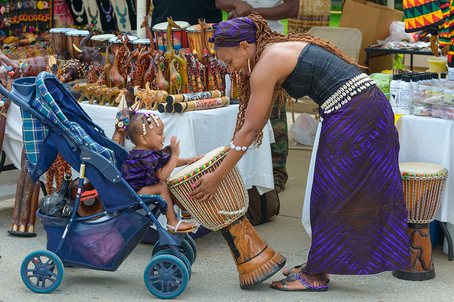 Image of a child and woman at a Juneteenth celebration.