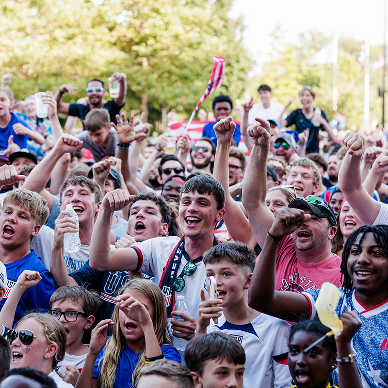 Image of people watching the screen at the Crew's outdoor plaza.