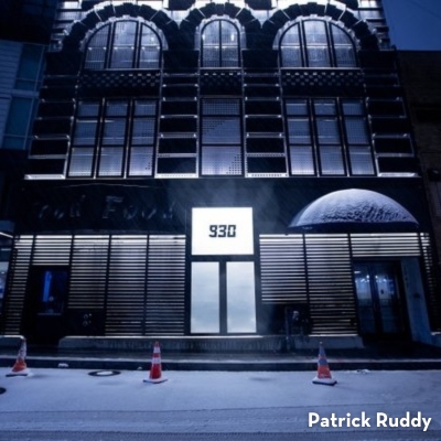 The illuminated facade of the 9:30 Club in Washington, DC, stands out at night with a glowing ''930'' sign above the entrance.
