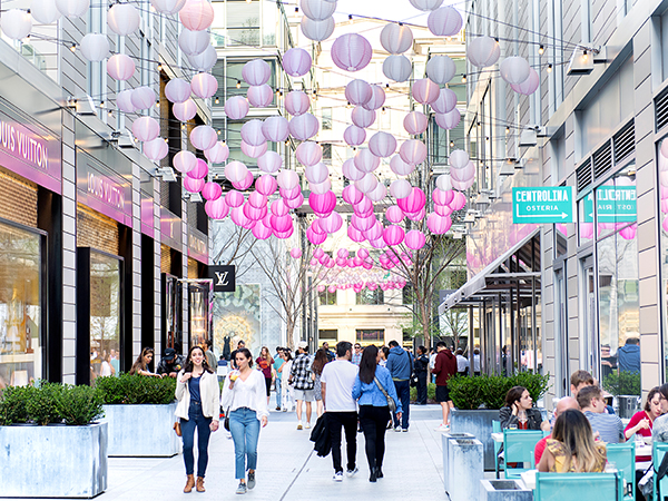 People walking through Palmer Alley decorated with pink lanterns