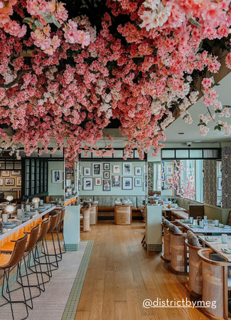 Restaurant with blossoms hanging from the ceiling 