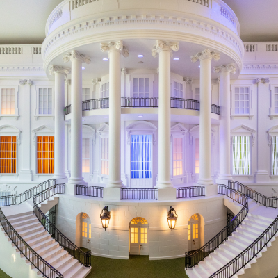 A detailed replica of the White House's South Portico, featuring grand staircases, tall white columns, and illuminated windows.