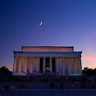 A Monuments by Moonlight group touring the Lincoln Memorial at night.