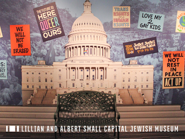Gallery photo featuring a large-scale photo mural of the capitol building and a selection of protest signs from the Collection.