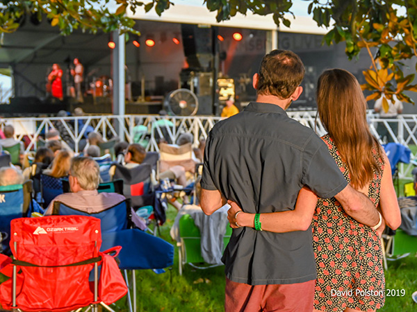A couple watches a concert on the lawn in Williamsburg, Virginia.