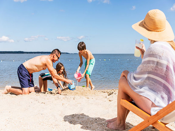 A family plays in the sand at Yorktown Beach.