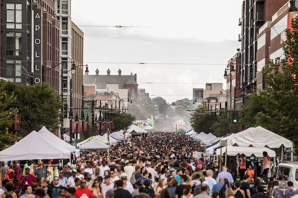 Large crowds fill H Street NE lined with vendor tents during the annual H Street Festival in Washington, DC.