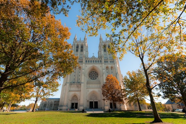 The Washington National Cathedral framed by colorful autumn trees in Washington, DC.