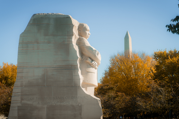 The Martin Luther King Jr. Memorial stands with the Washington Monument in the background on a fall day in Washington, DC.