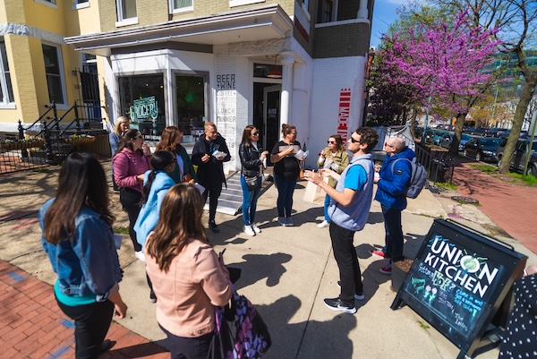 A group gathers outside Union Kitchen during a food tour in Washington, DC.