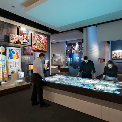 Visitors use an interactive table to learn about the life of Saint John Paul II in the exhibit at the Shrine.