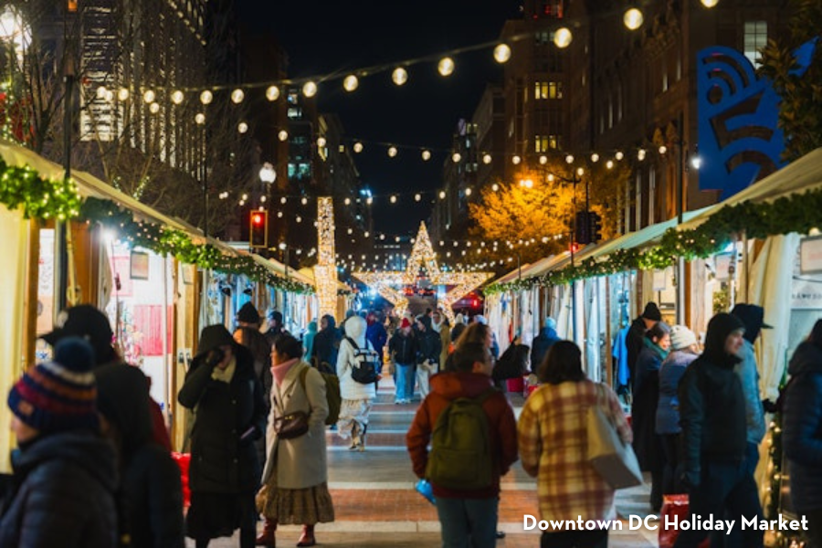 Shoppers browse festive stalls under twinkling lights at the Downtown DC Holiday Market.