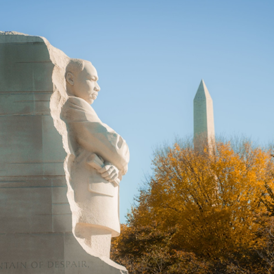 The Martin Luther King Jr. Memorial, with fall foliage and the Washington Monument in the background.