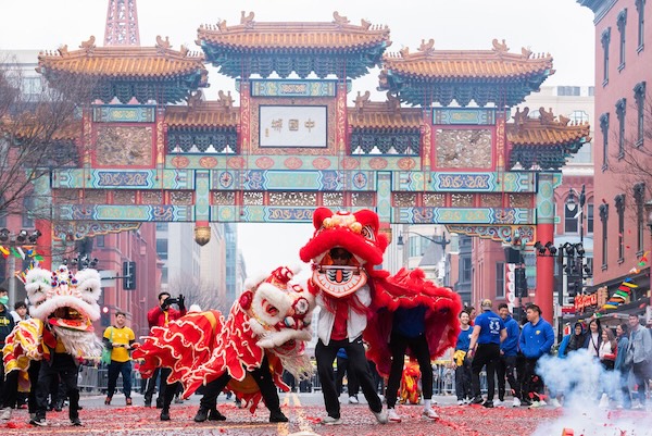 Performers in a red dragon costume dance through Chinatown during a Lunar New Year parade in Washington, DC.