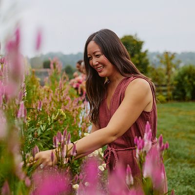 A woman admires spring blooms at Hope Flower Farm in Waterford.