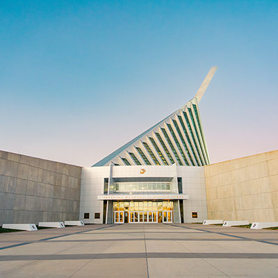 Exterior of the National Museum of the Marine Corps featuring its dramatic angular glass-and-steel spire rising above the museum entrance and open plaza.