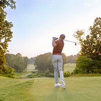 A golfer takes a swing on one of the Williamsburg area’s many notable courses. 