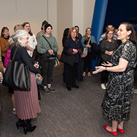A docent speaking to a group of visitors at the National Museum of the American Indian. 
