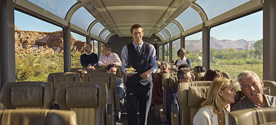 Train riders admiring mountain scenery