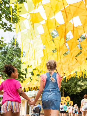 Girls Walking Beneath Kite Sky at Dollywood's Smoky Mountain Summer Celebration